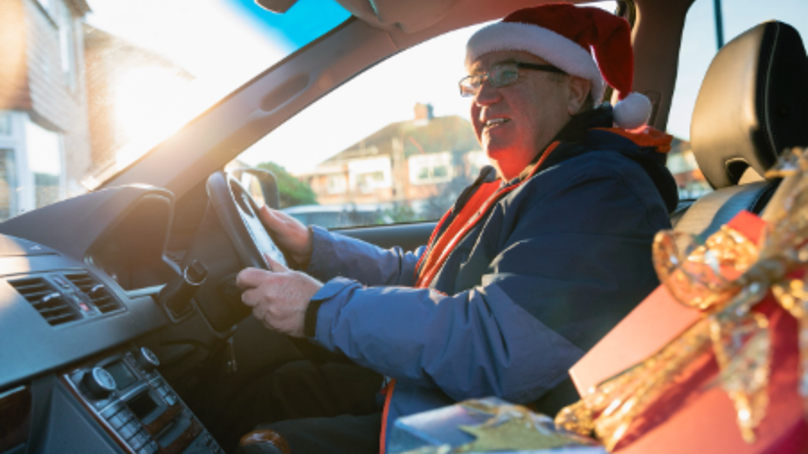 Man listening to the radio in the car at Christmas time