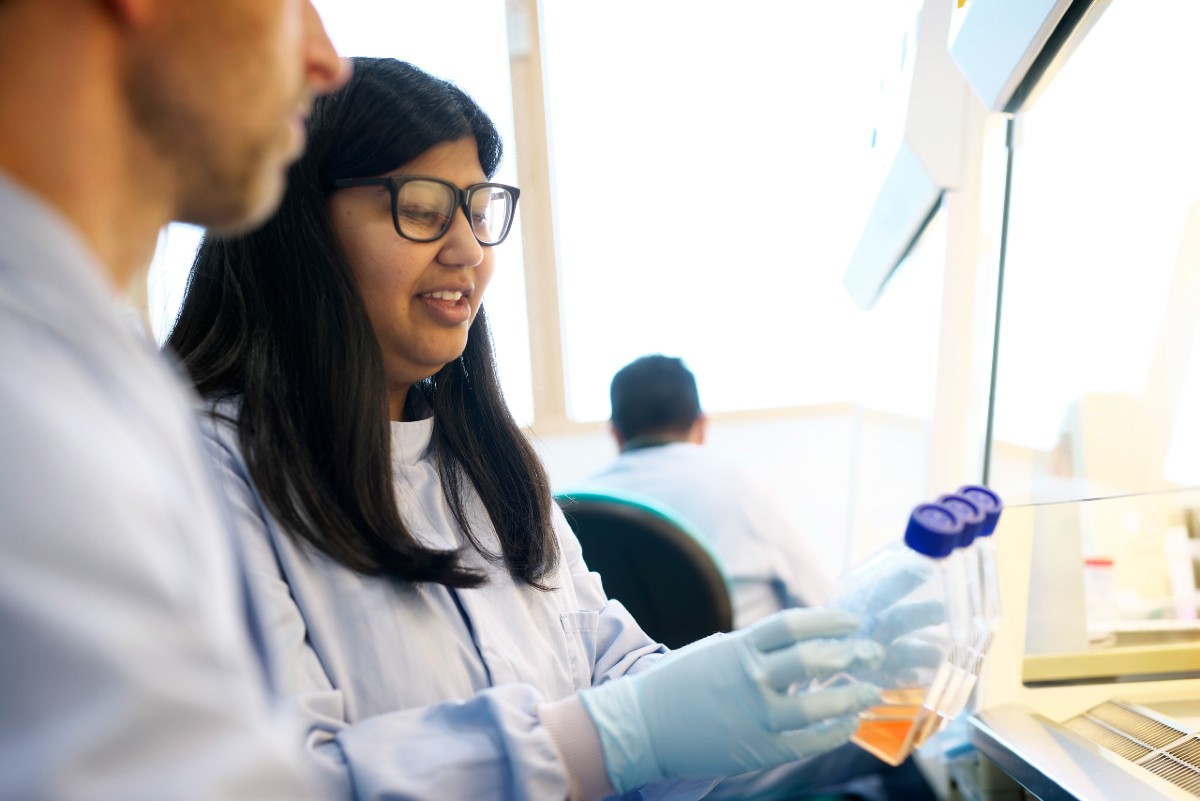 Two people in a lab looking at test tubes