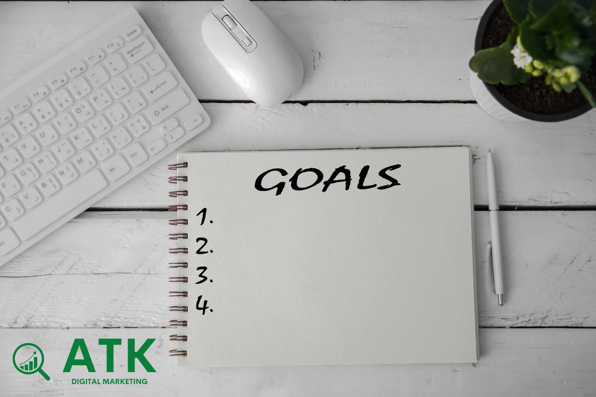 A clean white desk with a notebook titled 