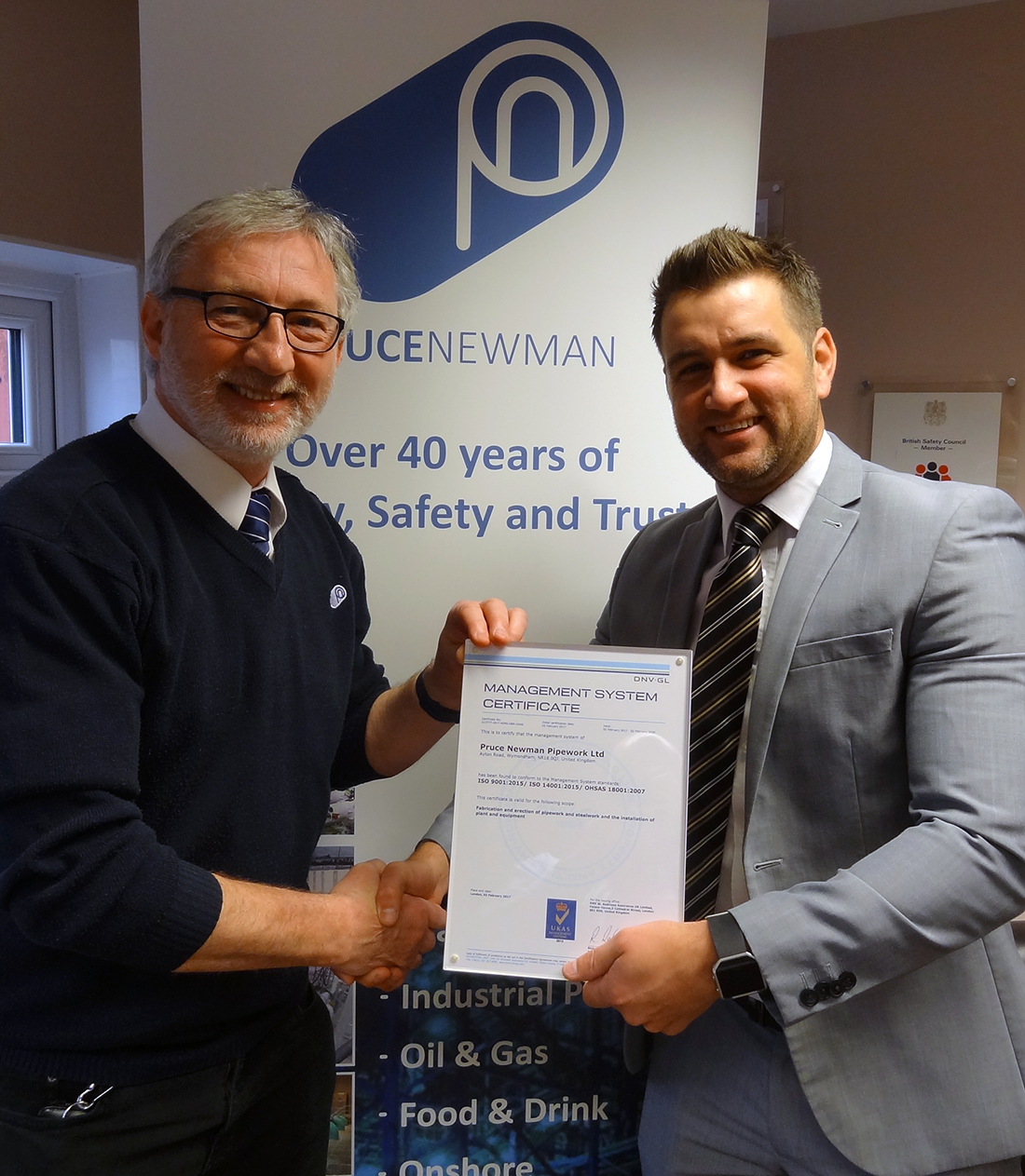 (l-r) Keith Dixon of Pruce Newman receives updated certification from Mark Clewley, DNV-GL