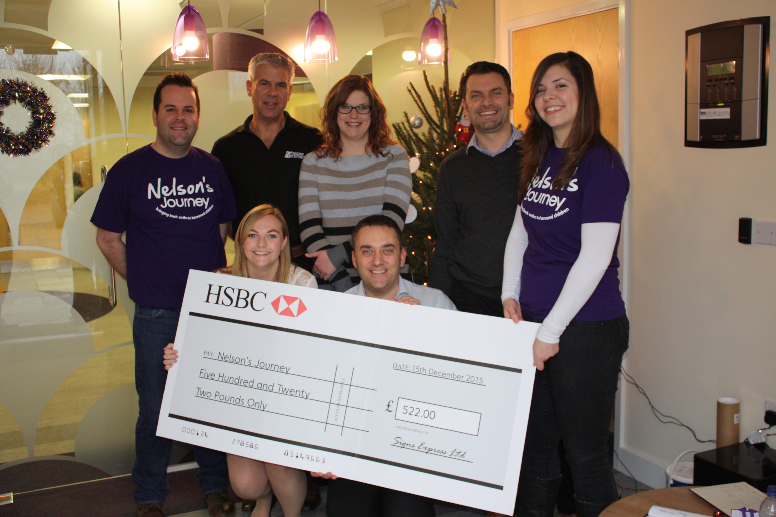 Nm The Signs Express Team Handing The Cheque Over To Nelsons Journey.jpg