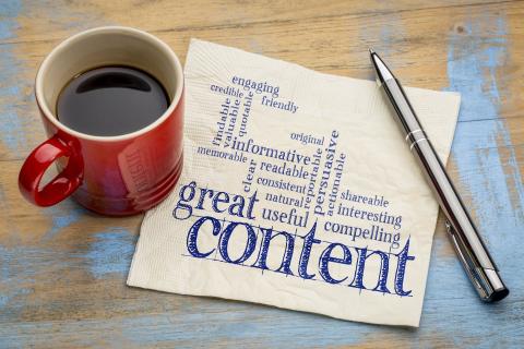 Content marketing image - mug and pen with napkin featuring words related to content marketing