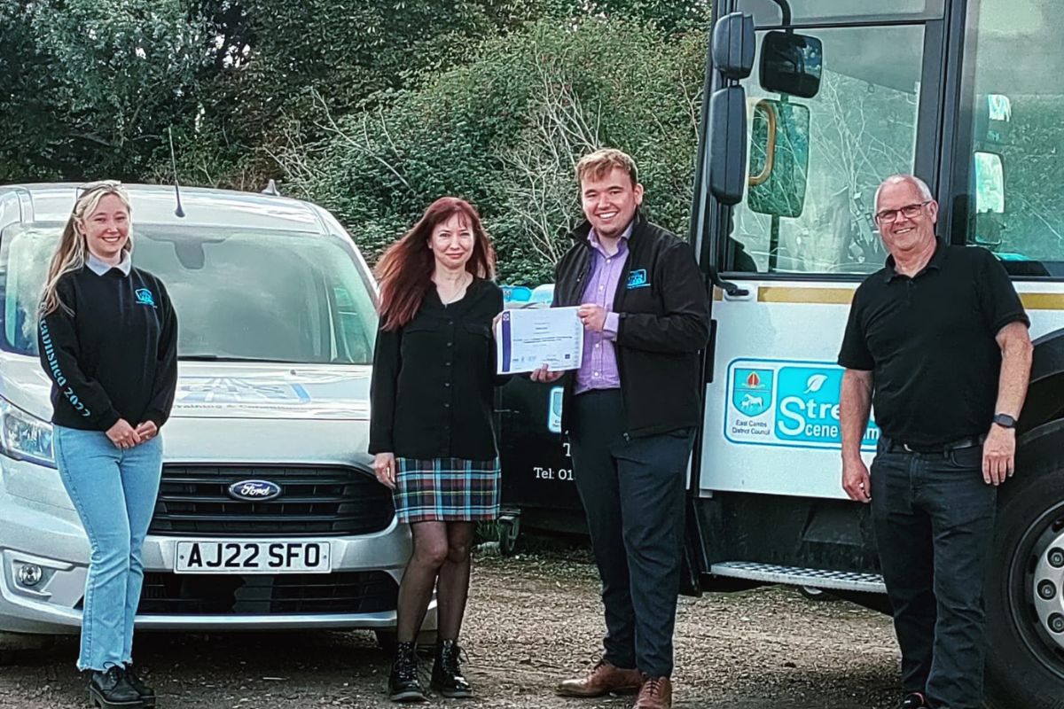 CTS presenting Claire from East Cambs District Council with her Transport Manager CPC certificate in front of the CTS van and an East Cambs Street Scene lorry