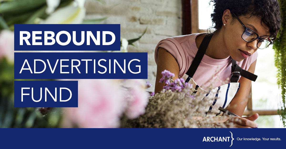 Rebound Advertising Fund. A female business owner studies some paperwork in a florist