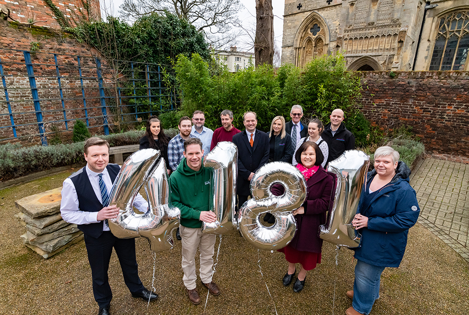 Freebridge employees celebrating the grand total raised with volunteers from the King’s Lynn Foodbank